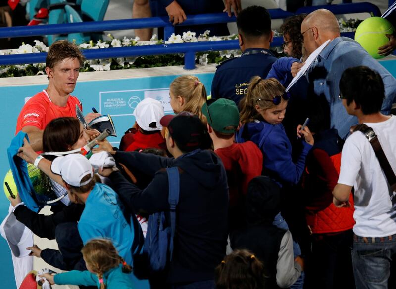 epa07250435 Kevin Anderson (L) of South Africa signs autographs after winning his match against Hyeon Chung of South Korea at the Mubadala World Tennis Championship 2018 in Abu Dhabi, United Arab Emirates, 27 December 2018.  EPA/ALI HAIDER