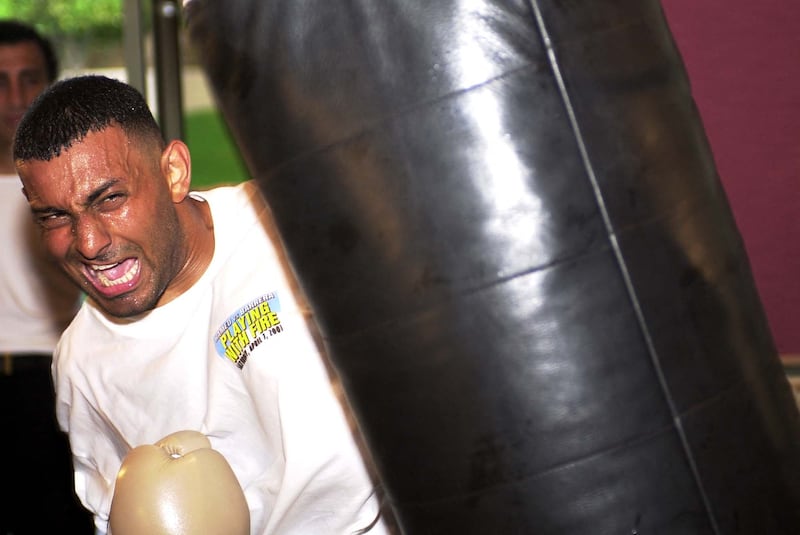 Featherweight champion Prince Naseem Hamed pounds a heavy bag in preparation for his fight with Mexican fighter Marco Antonio Barrera in 2001. AFP