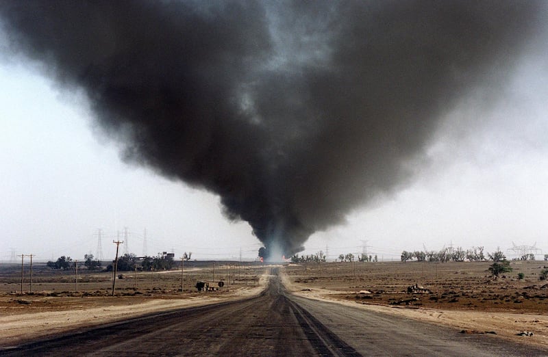 Several blown-out wells damaged by retreating Iraqi soldiers in Al-Ahmadi oil field burn 05 June 1991 in southern Kuwait. In 1991, Iraqi troops retreating after a seven-month occupation, smashed and torched 727 wells, badly polluting the atmosphere and creating crude oil lakes. In addition, up to eight billion barrels of oil were split into the sea by Iraqi forces damaging marine life and coastal areas up to 400 kilometres (250 miles) away. Kuwait will seek more than 16 billion dollars compensation for environment destruction brought by Iraq during the 1991 Gulf War, Kuwaiti newspaper Al-Anba said 07 December 1998. (Photo by MICHEL GANGNE / AFP)