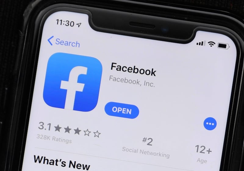 This Monday, July 30, 2019 photo shows an update information of Facebook application on a mobile phone displayed at a store in Chicago. The FBI is looking for outside contractors to monitor social media for potential threats, setting up a possible conflict with Facebook and other companies over privacy. (AP Photo/Amr Alfiky)