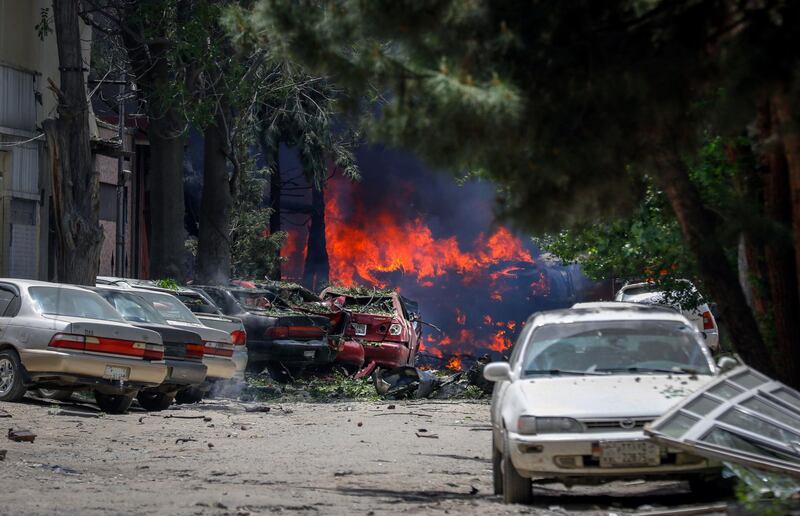 Fire takes hold and cars lie wrecked by the shockwaves.