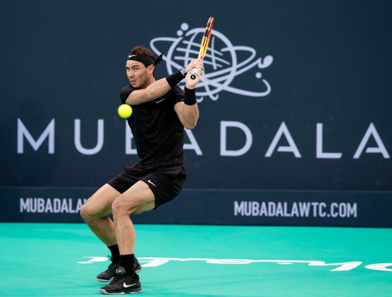 Rafael Nadal hits a backhand to Denis Shapovalov at the Mubadala World Tennis Championship. Victor Besa / The National