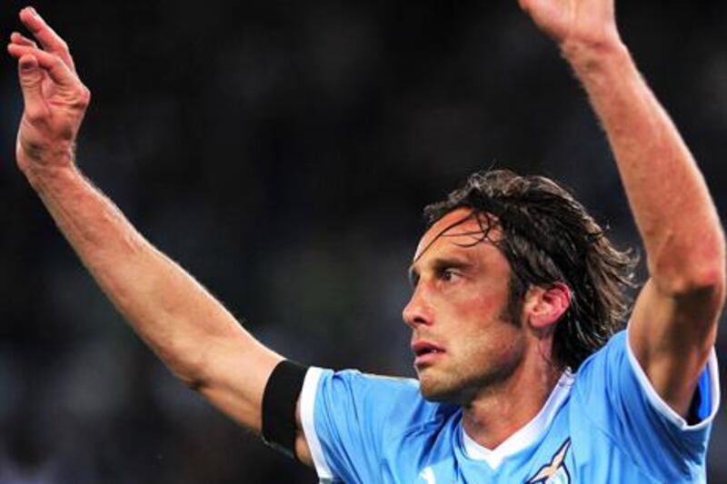 This file picture taken on May 13, 2012 shows Lazio's midfielder Stefano Mauri (R) during the Italian Serie A football match between Lazio vs Napoli at the Olympic Stadium in Rome on April 7, 2012. Mauri was was arrested early May 28 over the so-called Calcioscommesse sports betting scandal. AFP PHOTO / FILES / ALBERTO PIZZOLI

