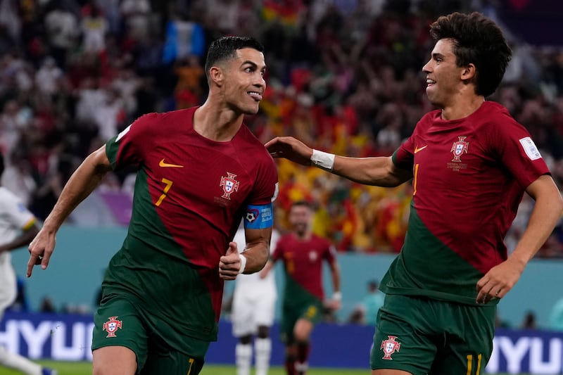 Portugal's Cristiano Ronaldo celebrates with teammate Joao Felix after scoring the opening goal in the 3-2 win against Ghana at the Stadium 974 in Doha on November 24, 2022. AP