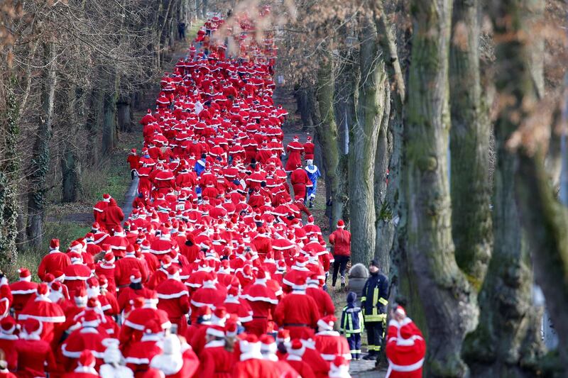 People dressed as Santa Claus run through the streets of Michendorf, Germany. Axel Schmidt / Reuters