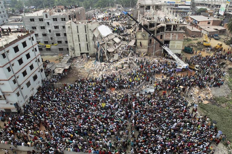 Rescuers look for survivors and victims amid the rubble of the Rana Plaza compound in Savar, near Dhaka, on April 25, 2013, a day after the building collapsed. A M Ahad / AP Photo 