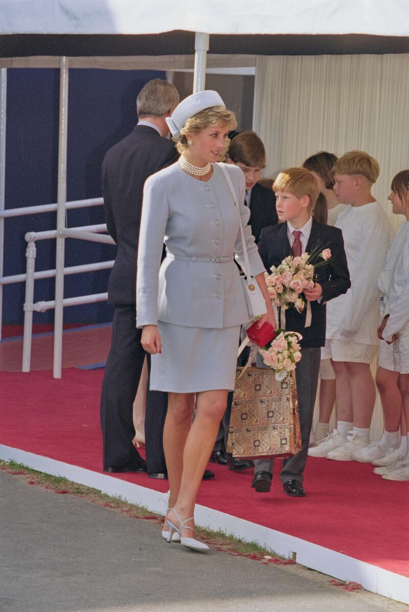 British Royal Diana, Princess of Wales (1961-1997), wearing a light blue suit and matching pillbox hat, with a multi-strand pearl necklace, and her son Prince Harry attending the Heads of State Victory in Europe Remembrance Service, marking the 50th anniversary of VE Day, in Hyde Park, London, England, 7th May 1995. (Photo by Princess Diana Archive/Hulton Archive/Getty Images)