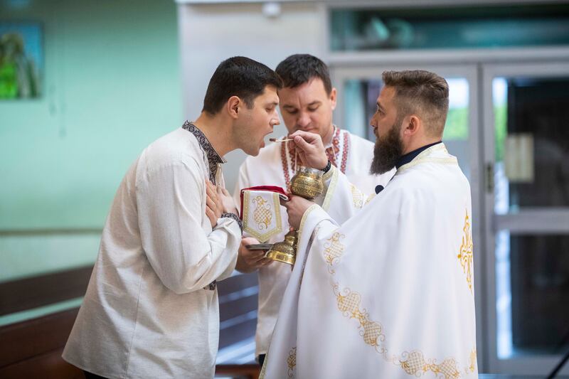 The priest blesses a devotee after the service to mark Orthodox Easter Sunday at the St. Joseph’s Cathedral in Abu Dhabi