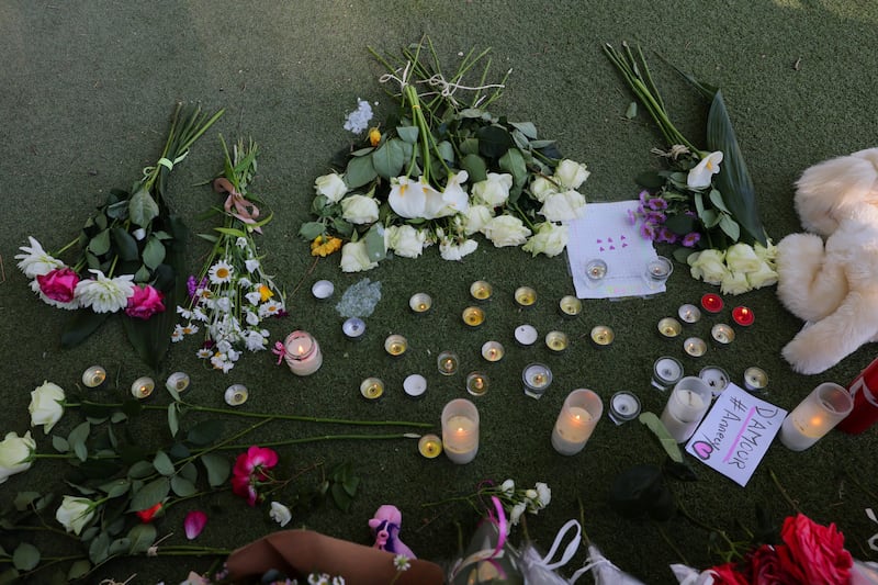 Flowers and candles left at Le Paquier park, where several children and adults were injured in the knife attack. Reuters