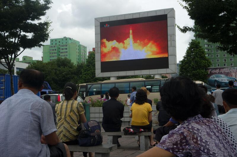 (FILES) This file photo taken on July 29, 2017 shows people watching as coverage of an ICBM missile test is displayed on a screen in a public square in Pyongyang.
North Korea slammed fresh UN sanctions imposed over its missile tests as an "act of war" on December 24, 2017, its first response to the latest diplomatic move to punish Pyongyang's ever-accelerating weapons drive.  / AFP PHOTO / Kim Won-Jin