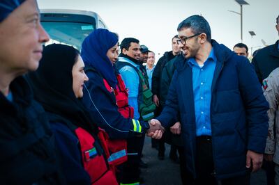 Sheikh Abdullah bin Zayed, Minister of Foreign Affairs and International Co-operation, shakes hands with Ayesha Foolad, a member of the UAE's search and rescue mission team that was sent to Turkey. Wam