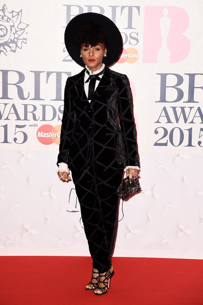 Janelle Monae, wearing a velvet suit by Emporio Armani with her Milner Gladys hat, attends the 2015 Brit Awards on February 25, 2015. Getty Images