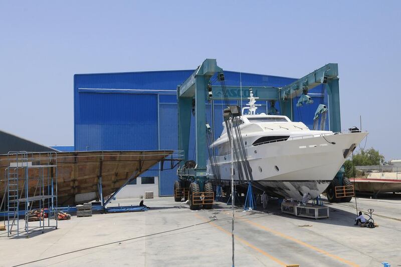 A yacht is lifted to be serviced at the Gulf Craft factory in Umm Al Quwain. Sarah Dea / The National