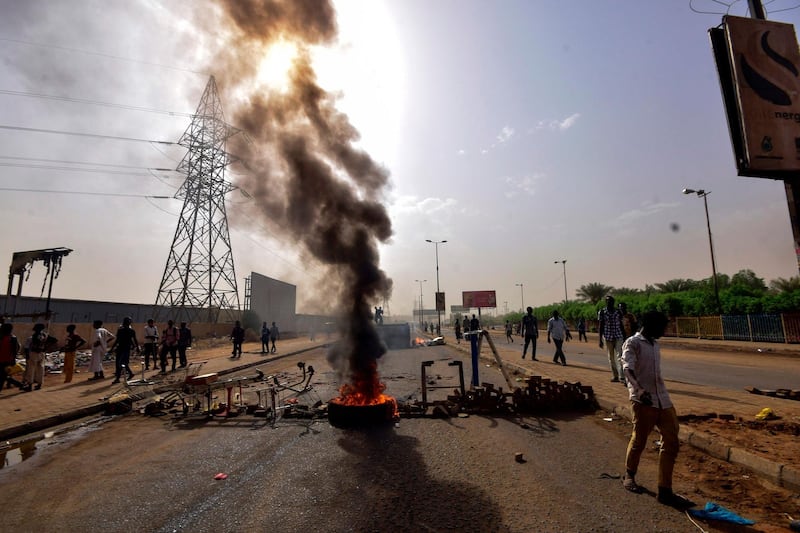 Sudanese protesters burn tyres and barricade the road in Khartoum's twin city of Omdurman. AFP