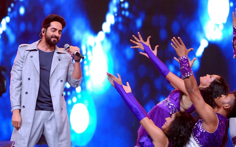 Bollywood actor and singer Ayushmann Khurrana, left, takes part in the' Umang Mumbai Police Show 2018. Sujit Jaiswal / AFP