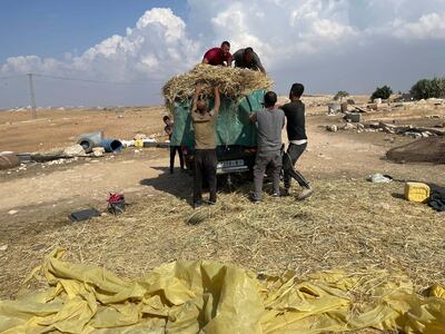 Villagers pack their belongings as they prepare to leave Khirbet Zanuta in the occupied West Bank. Photo: The National