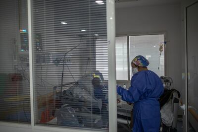 In this photo taken on Wednesday, April 15, 2020, a healthcare worker assists a COVID-19 patient at one of the intensive care units (ICU) of the Moulay Abdellah hospital in Sale, Morocco. Coronavirus has upended life for Morocco's medical workers. They enjoy better medical facilities than in much of Africa but are often short of the equipment available in European hospitals, which also found themselves overwhelmed. (AP Photo/Mosa'ab Elshamy)