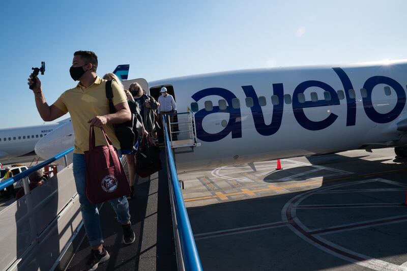 A passenger wearing a protective mask disembarking from the first Avelo Airlines flight. Bloomberg
