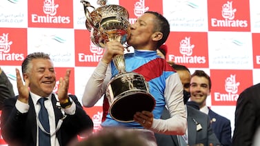 Lanfranco Dettori (no 3) with the trophy after winning the 9th horse race Dubai World Cup 2000m dirt during the Dubai World Cup 2022 held at Meydan Racecourse in Dubai. Pawan Singh / The National