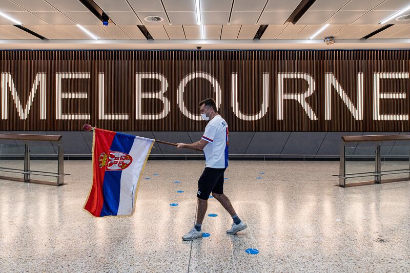 Supporter Slobodan Bendjo holds a Serbian flag as he waits for the latest news about Novak Djokovic being held by the Australian Border Force due to a visa issue at Melbourne Airport on January 05, 2022. Getty Images