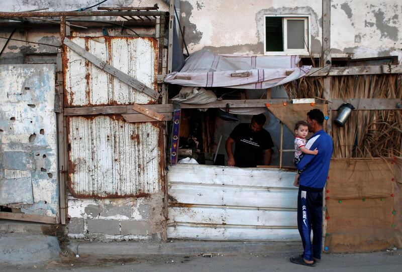 A Palestinian man repairs stoves in a makeshift shop amid the coronavirus crisis, at the beach refugee camp in Gaza City. Reuters