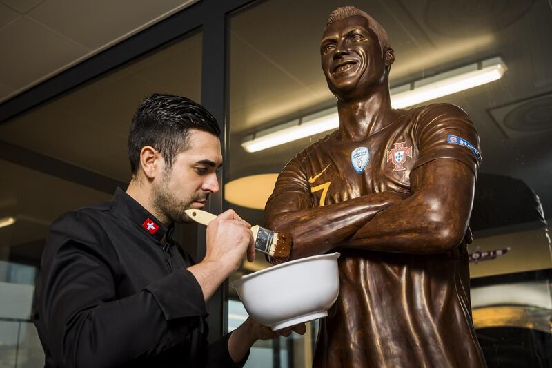 Portuguese chocolatier Jorge Cardoso with life-size sculpture of footballer Cristiano Ronaldowhich was made entirely out of chocolate, at the Suard chocolatier factory in Givisiez near Fribourg, Switzerland, on Thursday, February 6. The sculpture took the chocolatier around 200 hours to complete. EPA