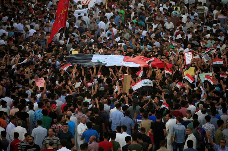 People gather during a protest in the city of Najaf, Iraq. Reuters