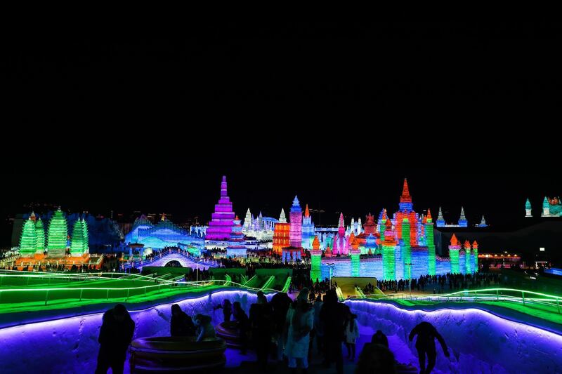 People visit ice sculptures illuminated by colored lights at the Ice and Snow World during the opening ceremony of the annual Harbin International Ice and Snow Sculpture Festival in China. EPA