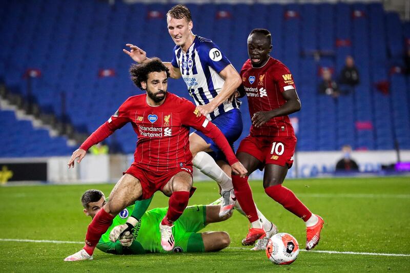 epa08535496 Liverpool's Mohamed Salah (front-L) and teammate Sadio Mane (R) in action against Brighton's goalkeeper Mathew Ryan (buttom) and Dan Burn (C) during the English Premier League match between Brighton & Hove Albion and Liverpool FC in Brighton, Britain, 08 July 2020.  EPA/Cath Ivill/NMC/Pool EDITORIAL USE ONLY. No use with unauthorized audio, video, data, fixture lists, club/league logos or 'live' services. Online in-match use limited to 120 images, no video emulation. No use in betting, games or single club/league/player publications.