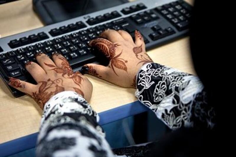 GENERIC CAPTION!
Adorned by traditional henna hand tattoos, a young Emirati girl works on a computer during a computer science class, on Thursday morning, April 28, 2011, at the Butti Public School in Bani Yas. (Silvia R·zgov· / The National)





