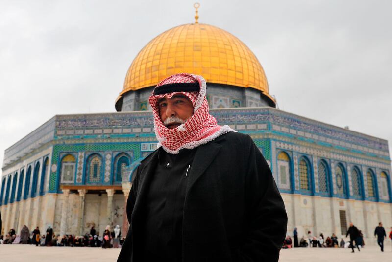 A Palestinian Muslim worshipper walks past the Dome of the Rock mosque inside Jerusalem's Al-Aqsa mosques compound. AFP