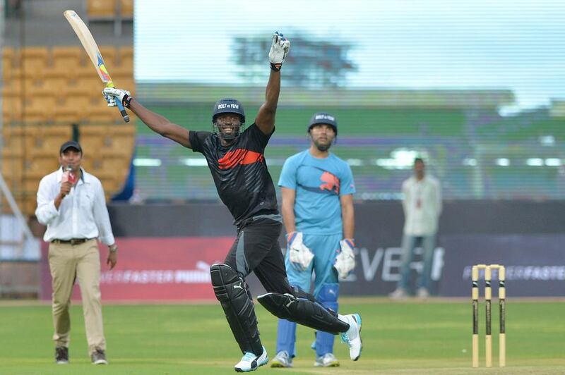 Usain Bolt celebrates after his team beats Yuvraj Singh's in the four-over exhibition cricket match on Tuesday in Bangalore. Manjunath Kiran / AFP