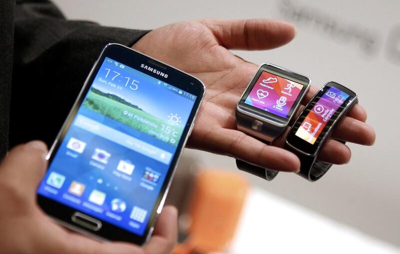 New Samsung Galaxy S5 smartphone, Gear 2 smartwatch and Gear Fit fitness band. Albert Gea / Reuters