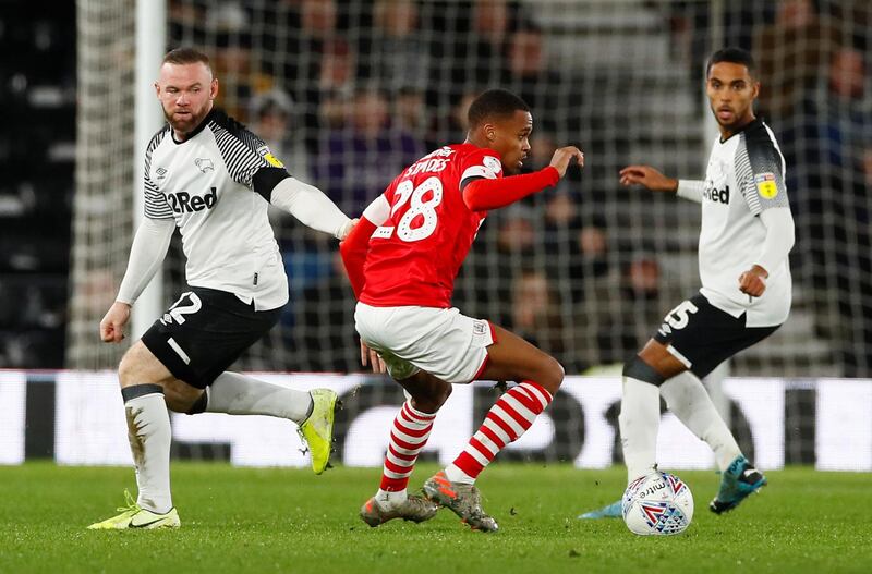 Wayne Rooney and Barnsley's Elliot Simoes. Reuters