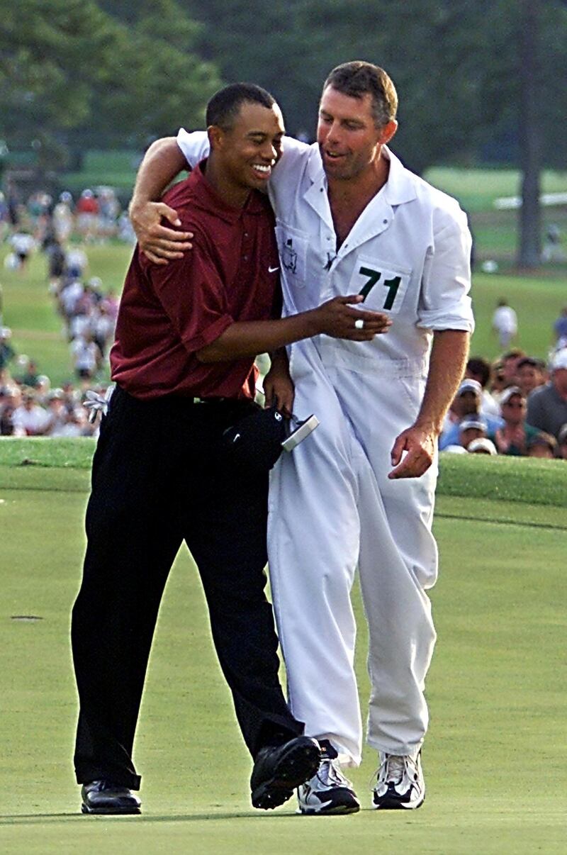 Tiger Woods (L) celebrates with caddy Steve Williams after winning the 2001 Master at the Augusta National Golf Club, 08 April 2001,  in Augusta, Georgia.  Woods held his nerve in one of the most thrilling final days in Masters history in Augusta 08 April, to become the first player ever to hold all four Major titles at the same time.    AFP PHOTO/Robert SULLIVAN (Photo by ROBERT SULLIVAN / AFP)