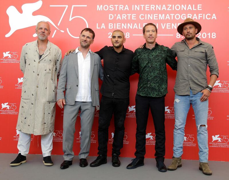 Producer Marc du Pontavice, left, director David Oelhoffen, second left, actors Sofiane Zermani, centre, Reda Kateb, second right, and Matthias Schoenaerts, right, pose for photographers at the photo call for the film 'Close Enemies' at the 75th edition of the Venice Film Festival in Venice, Italy, Saturday, Sept. 1, 2018. (AP Photo/Kirsty Wigglesworth)