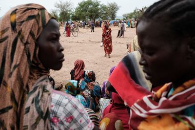 Women wait to receive food cards after registering as new arrivals at a camp for internally displaced persons in Agari, North Kordofan.  AFP