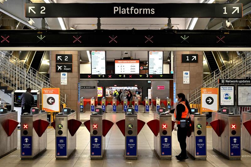 A worker disinfects gates to platforms at Circular Quay train station in Sydney.  Australia has been relatively successful in containing the spread of the coronavirus, with about 27,500 cases and 905 deaths in a population of 25 million.  AFP