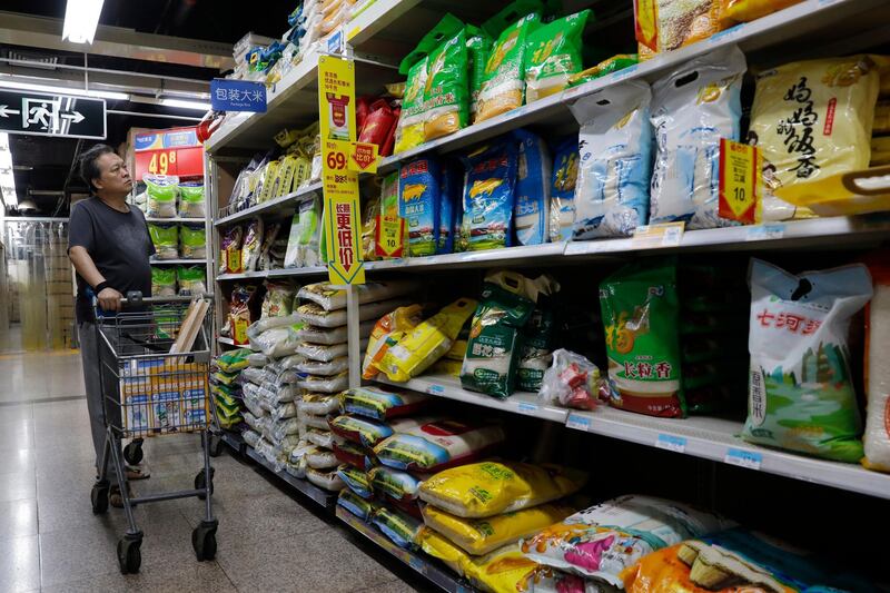 epa07029393 A Chinese man looks at a variety of rice products in a super market in Beijing, China, 18 September 2018. The US announced 17 September they are imposing new tariffs worth 200 billion US dollars on almost 6,000 Chinese goods including handbags, rice and textiles. These taxes will take effect from 24 September 2018, starting at a level of 10 percent and increasing to 25 percent from the beginning of next year, according to media reports.  EPA/WU HONG