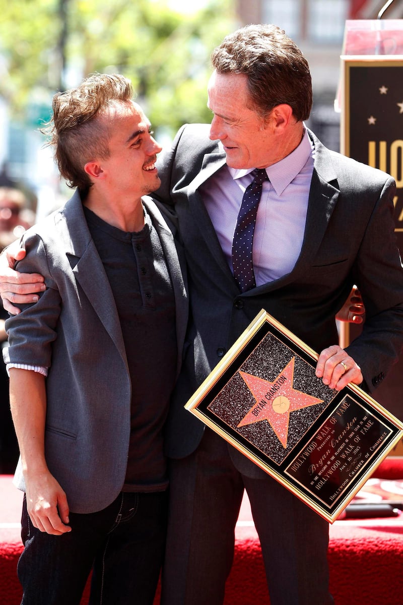 Actor Bryan Cranston poses with actor Frankie Muniz (L) during ceremonies unveiling his star on the Hollywood Walk of Fame in Hollywood July 16, 2013. Cranston and Muniz starred in the comedy series "Malcolm in the Middle" and Cranston currently stars in the AMC drama series "Breaking Bad." REUTERS/Fred Prouser 
(UNITED STATES - Tags: ENTERTAINMENT) *** Local Caption ***  LAB12_USA-_0716_11.JPG