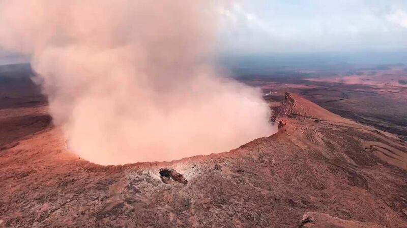Ash from the Puu Oo vent on Kilauea volcano rises into the air, near Pahoa, Hawaii. US Rep Tusli Gabbard / National Guard via AP