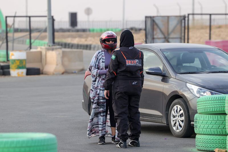 Almarglani talks to one of her students at Derab circuit. AFP