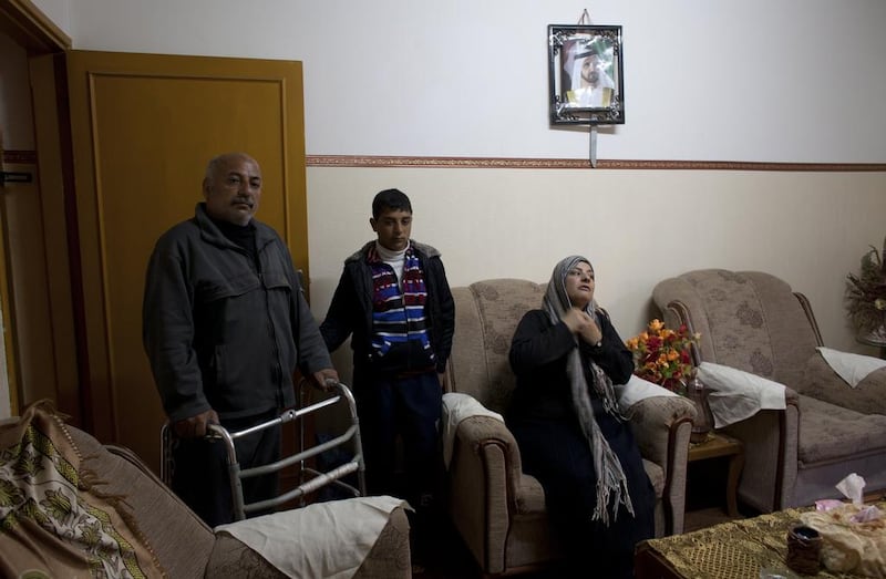 Majda Walid, 43 and her husband  Nahed Abu Safi, 50 and their son Salah ,16, inside their apartment in Sheikh Zayed City. Heidi Levine for The National
