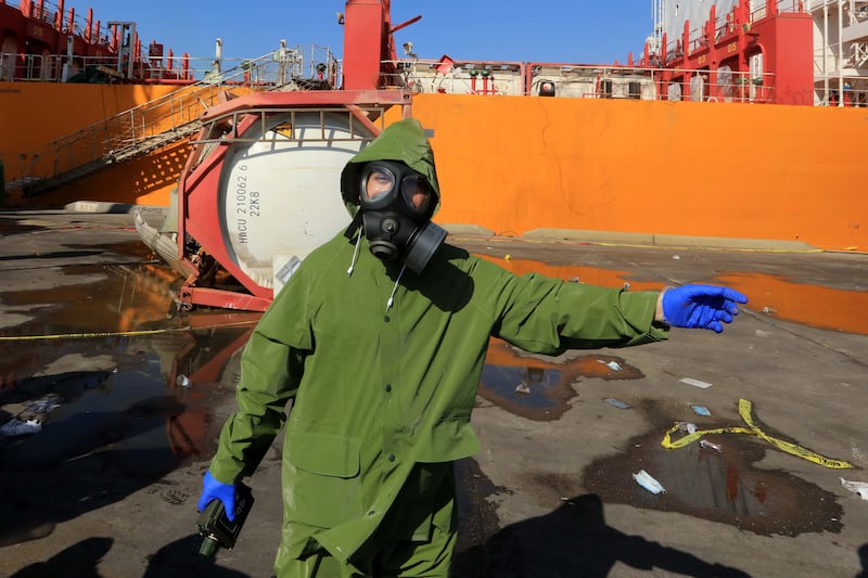 Authorities investigate the scene of the aftermath of the explosion of a tank containing large amounts of the toxic chlorine gas in Aqaba. EPA