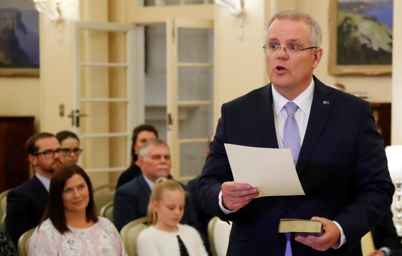 The new Australian Prime Minister Scott Morrison attends a swearing-in ceremony as his wife Jenny looks on, in Canberra, Australia August 24, 2018.  REUTERS/David Gray