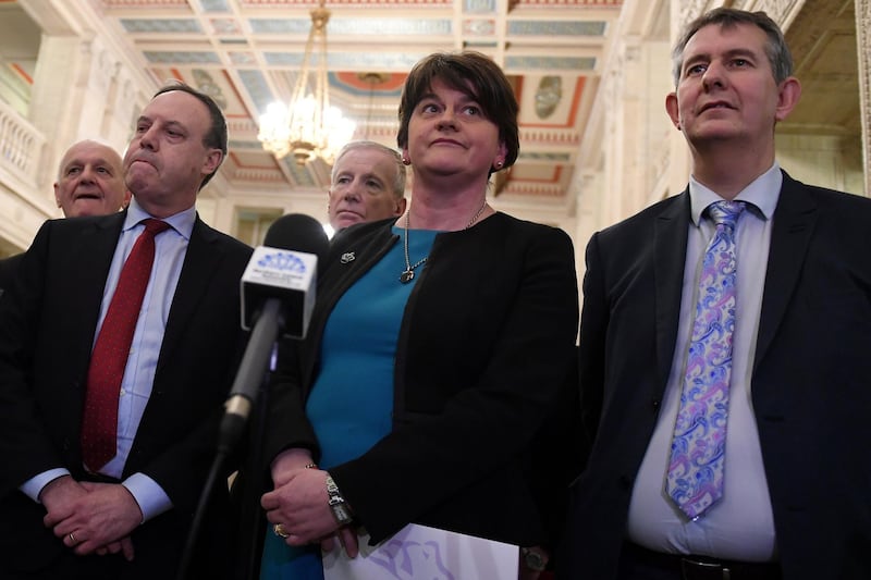 FILE PHOTO: DUP leader Arlene Foster (C) arrives at a news conference in Parliament Buildings at Stormont in Belfast, Northern Ireland February 12, 2018. REUTERS/Clodagh Kilcoyne/File Photo