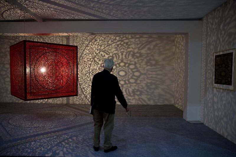 A man watches an art by Anila Quayyum Agha during India Art Fair in New Delhi, India. The four day art fair brings together a number of modern and contemporary artists to present their works. Tsering Topgyal / AP photo