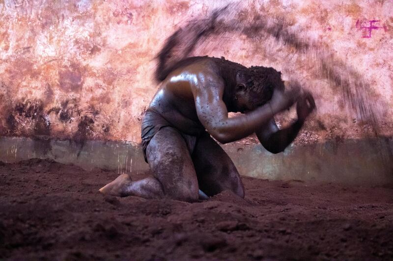 Wrestlers cover themselves with the mud before preparing for a bout ensuring they maintain the grip. Sanket Jain for The National