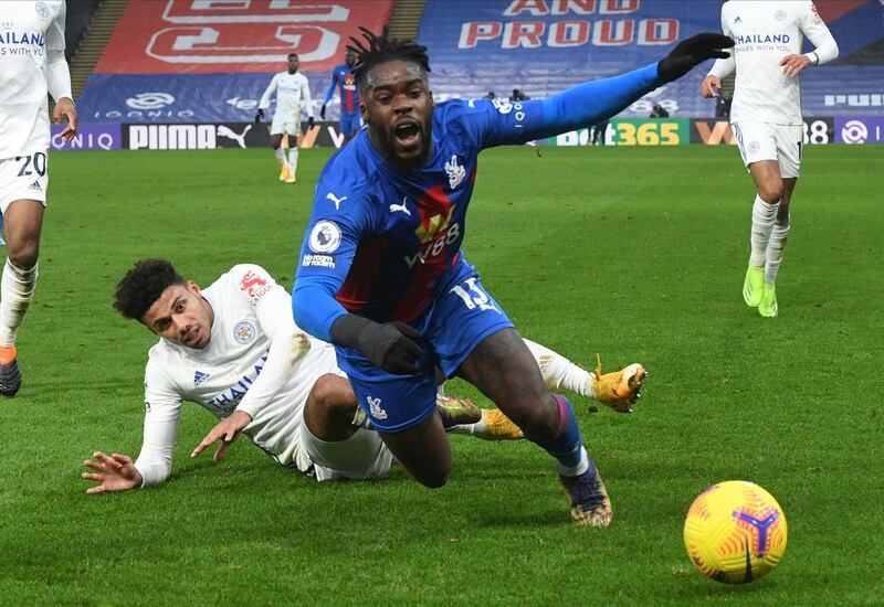 Leicester City's James Justin, left, and Crystal Palace's Jeffrey Schlupp challenge for the ball. AP