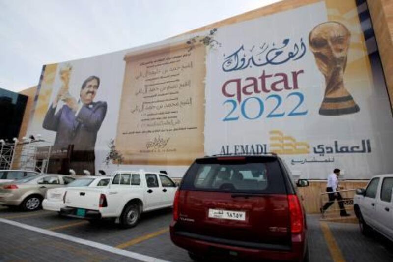 A banner featuring the Qatar 2022 World Cup is hang on the building in Doha, Qatar, Thursday, Jan. 6, 2011. AFC Asian Cup soccer match will kick off on Jan. 7.  (AP Photo/Kin Cheung) *** Local Caption ***  XKC104_Qatar_Asian_Cup_Soccer.jpg